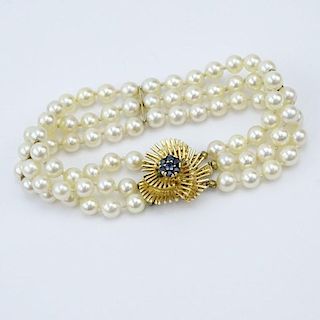 Vintage Three Strand Pearl Bracelet with 14 Karat Yellow Gold and Sapphire Clasp.