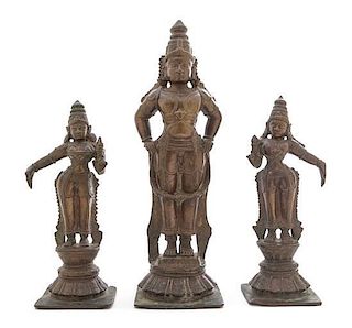 * An Indian Bronze Triad of Vishnu with Consorts Height of tallest 16 1/4 inches. 印度毗湿奴立像及侍從一組三件，19世纪，高16.25英
