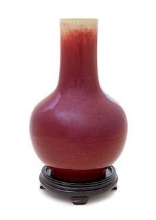 A Sang-de-Boeuf Glazed Porcelain Bottle Vase Height 12 1/2 inches. 祭紅釉長頸瓶，高12.5英吋