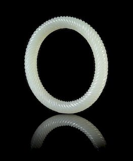 A Pale Celadon Jade Spiral Twist Bangle Diameter 3 inches. 青白玉旋纹镯，直徑3英吋