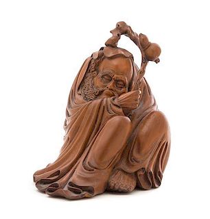 A Carved Rosewood Figure of a Seated Monk Height 7 inches. 木雕僧坐像，高7英吋