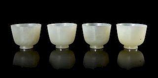 A Set of Four Pale Celadon Jade Wine Cups Height of largest 1 1/2 inches x Diameter 2 inches. 青白玉酒盃四件，高1.5英吋，直徑2英寸