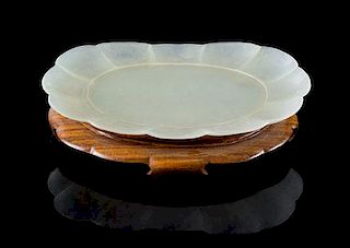 * A Pale Celadon Jade Dish Length 4 3/8 inches. 青白玉菊形小碟，長4.375英吋