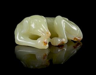 A Yellow Jade Figure of a Recumbent Dog Length 2 1/4 inches. 黄玉雕卧狗，長2.25英吋