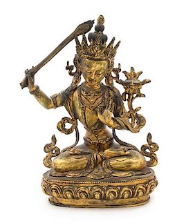 * A Sino-Tibetan Gilt Bronze Figure of a Bodhisattva Height 11 inches. 铜鎏金菩萨坐像，高11英吋