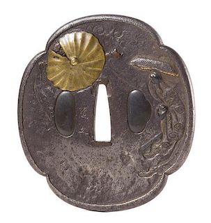 A Gilt Bronze Inlaid Iron Tsuba Height 3 1/4 inches.