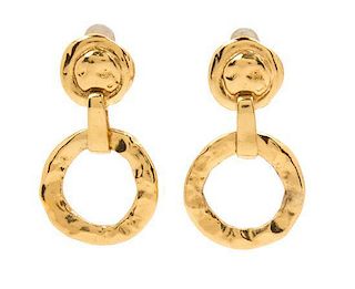 A Pair of Yves Saint Laurent Goldtone Hammered Earclips, 2.5" x 1.5".