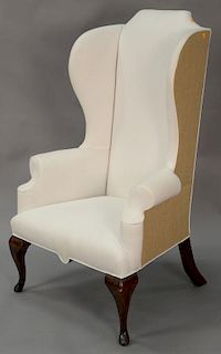 Queen Anne style wing chair with white upholstery.