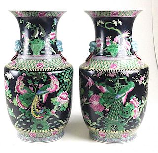 Pair of Chinese porcelain vases of black enamel field with molded ring & dog handles, overall bird and floral decoration, marked on botton for "Da Qin