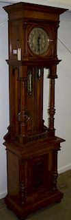 19th c Neoclassical carved walnut tall cased grandfather clock, brass movement, carved panel, turned columns. 85"h.