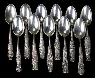 Group of 11 George W. Shiebler "Flora" teaspoons in excellent condition. 11 separate floral patterns, numbers 1-7 and 9-12. 11.1 troy oz.