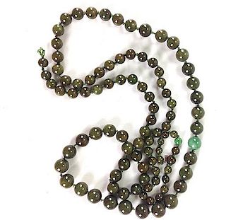 Chinese graduated strand of deep green jade beads with spinach green jade center bead, ranging from 5.5mm to 8.5" 31" L.