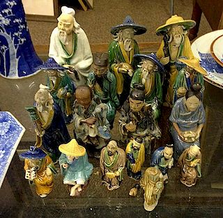 Collection of 18 Chinese glazed mud men figures ranging from 3" to 8.5" ht.