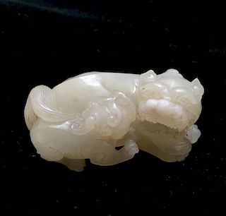 AN ANTIQUE CARVED WHITE JADE LIONS, QING DYNASTY