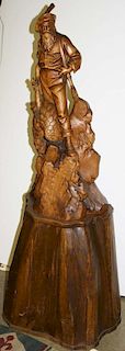 early 20th c German Black Forest carving of a hunter with game,signed J Fuchs, set on a hollow base, ht 29.5ﾔ, overall ht 49ﾔ