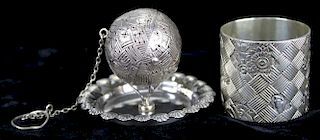 Ornate Gorham sterling tea ball infuser and unmarked sterling stand. Tea ball is round with basket weave  pattern and floral accents. Hinged halves wi