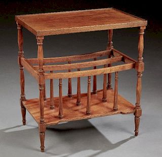 English Carved Mahogany Canterbury, 20th c., the dished rectangular top on ring turned tapered legs with French toes joined by a lower shaped stretche