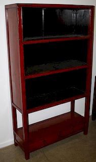 Chinese elm tall bookcase shelves over two short doors. Red paint. Early 20th c. 76"h x 42½"w.