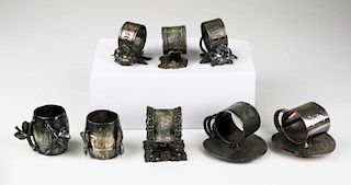 lot of 8 silver plated napkin rings incl; floral, lily pad, and barrell form  2"-2.5" ht.