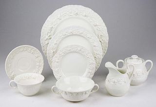 63 pcs Wedgwood cream Queensware with embossed grape vine border; incl. serving bowls, dinner plates, sugar & creamer, bouill