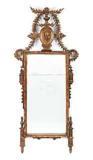 Louis XVI style carved and gilded mirror with neoclassical decoration