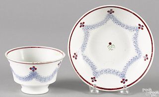 Blue spatter drape pattern cup and saucer, 19th c., with red flowers.