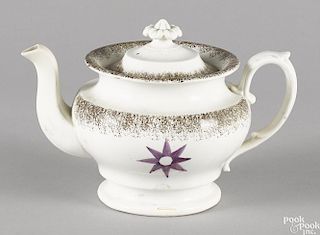 Brown spatter teapot with a purple star, 6'' h.