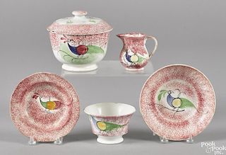 Red peafowl spatter, to include a cup and saucer, a small creamer, a small shallow bowl
