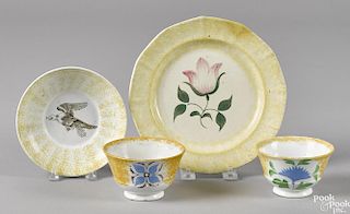 Four pieces of yellow spatter, to include a plate with a tulip, 8 1/4'' dia., a saucer