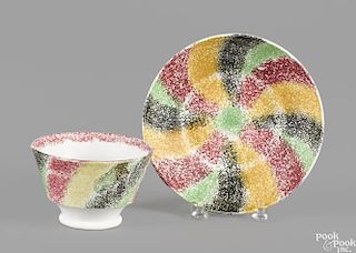 Red, green, yellow, and black rainbow spatter swirl pattern cup and saucer, 19th c.