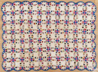 Pennsylvania patchwork double wedding ring crib quilt, early 20th c., with a scalloped border