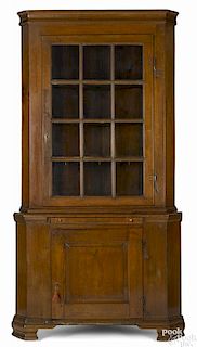 Pennsylvania walnut two-part corner cupboard, late 18th c., retaining its original rattail hinges