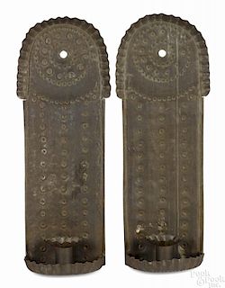 Pair of tin sconces, 19th c., with punched decoration, 13 3/4'' h., 4 3/8'' w.