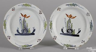 Pair of Delft polychrome sporting fish plates, 18th c., 8 3/4'' dia.