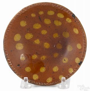 Miniature Pennsylvania redware pie plate, 19th c., with yellow polka dot decoration, 4 3/8'' dia.
