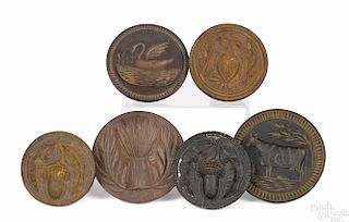 Six turned and carved butterprints, 19th c., to include an eagle, a cow, a swan, wheat