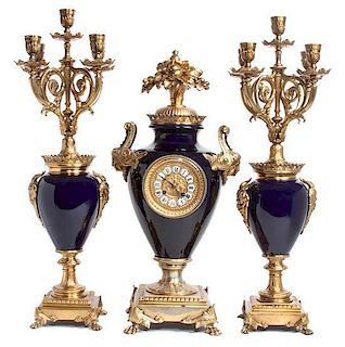 A French Blue Porcelain and Gilt Bronze Clock Garniture Height 23 x width 7 x depth 11 inches.