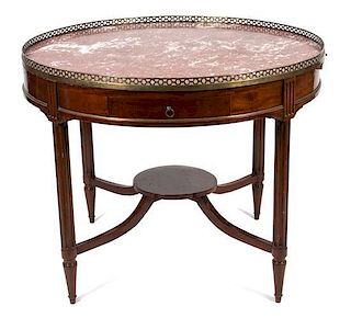 A Louis XVI Style Mahogany Bouillotte Table Height 32 x diameter 40 1/2 inches.