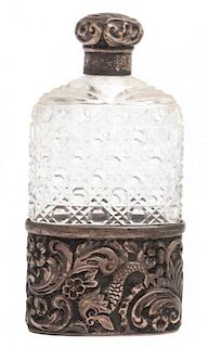 An English Silver Mounted Hip Flask, Finnigans Ltd., Manchester, having a cut glass bottle mounted in a silver base with silver
