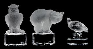 * A Lalique Molded and Frosted Glass Paperweight Height of first 2 5/8 inches.