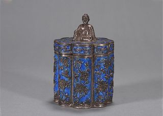 A flower patterned silver enamel covered jar