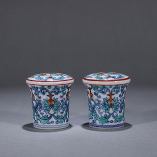 A pair of doucai interlocking flower porcelain scroll heads