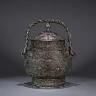 A taotie patterned loop-handled copper pot