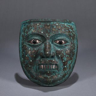 An inscribed gold and silver inlaid bronze mask