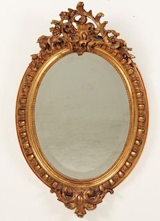 PETITE FRENCH CARVED GILTWOOD AND GESSO OVAL MIRROR