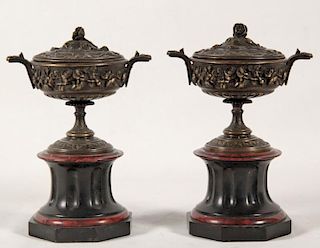 PAIR OF FRENCH CLASSICAL RAISED FLORAL DESIGN BRONZE CAPPED URNS