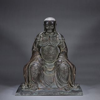 A copper sitting Guangong statue