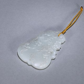 An inscribed gourd shaped jade pendant
