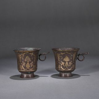 A pair of interlocking flower patterned silver cups