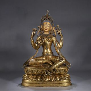 A gem inlaid copper four-armed buddha statue